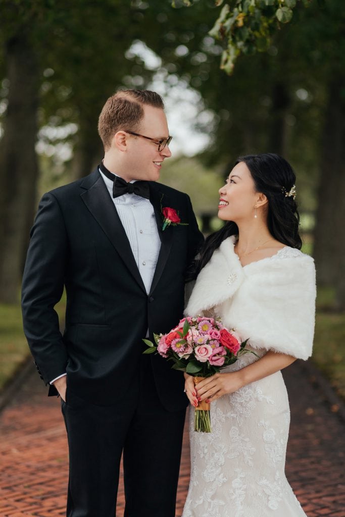 A bride and groom looking at each other during their portrait session