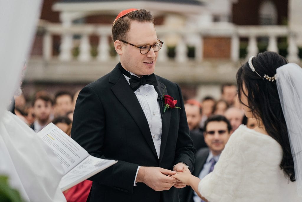A groom looking at her beloved bride during a wedding ceremony