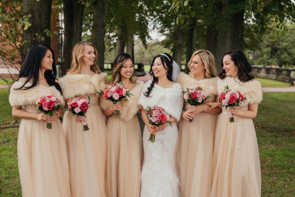 A bride and her bridesmaids posing for a picture at Bourne Mansion, Oakdale, NY