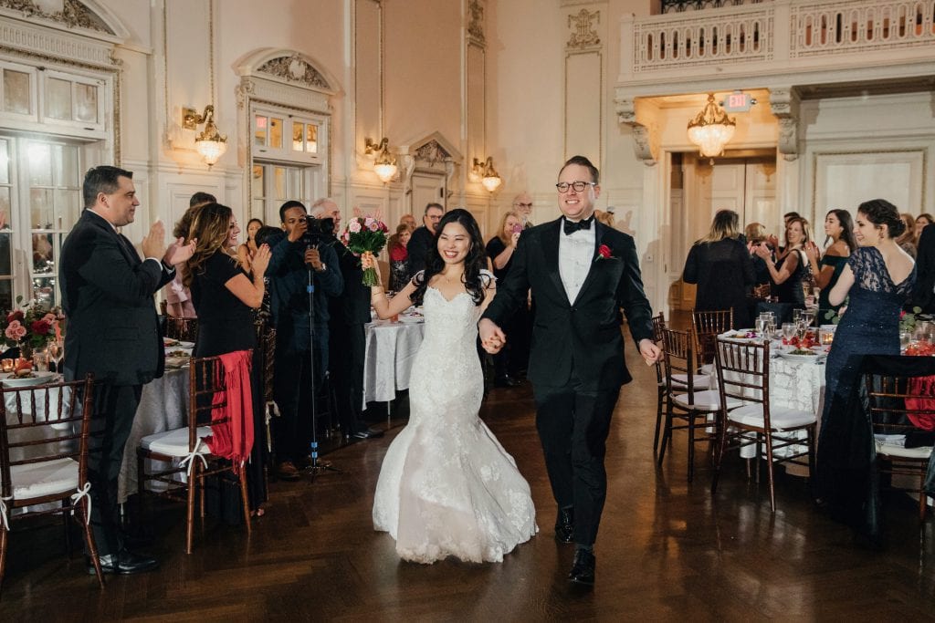 A newly wedded couple entering to the wedding reception