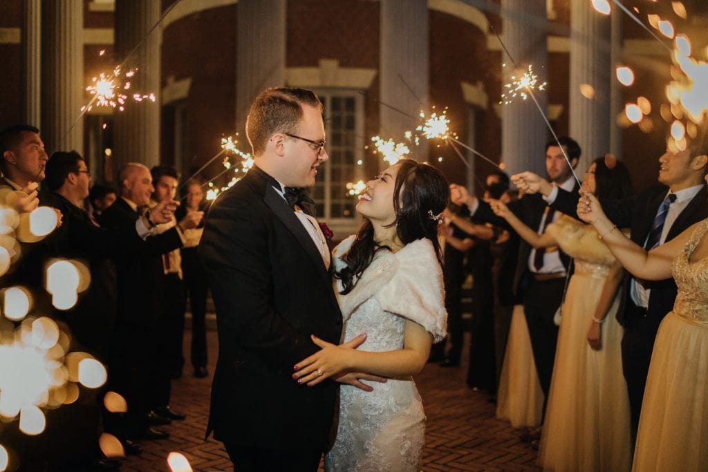 A bride and groom exiting their wedding venue end of the night