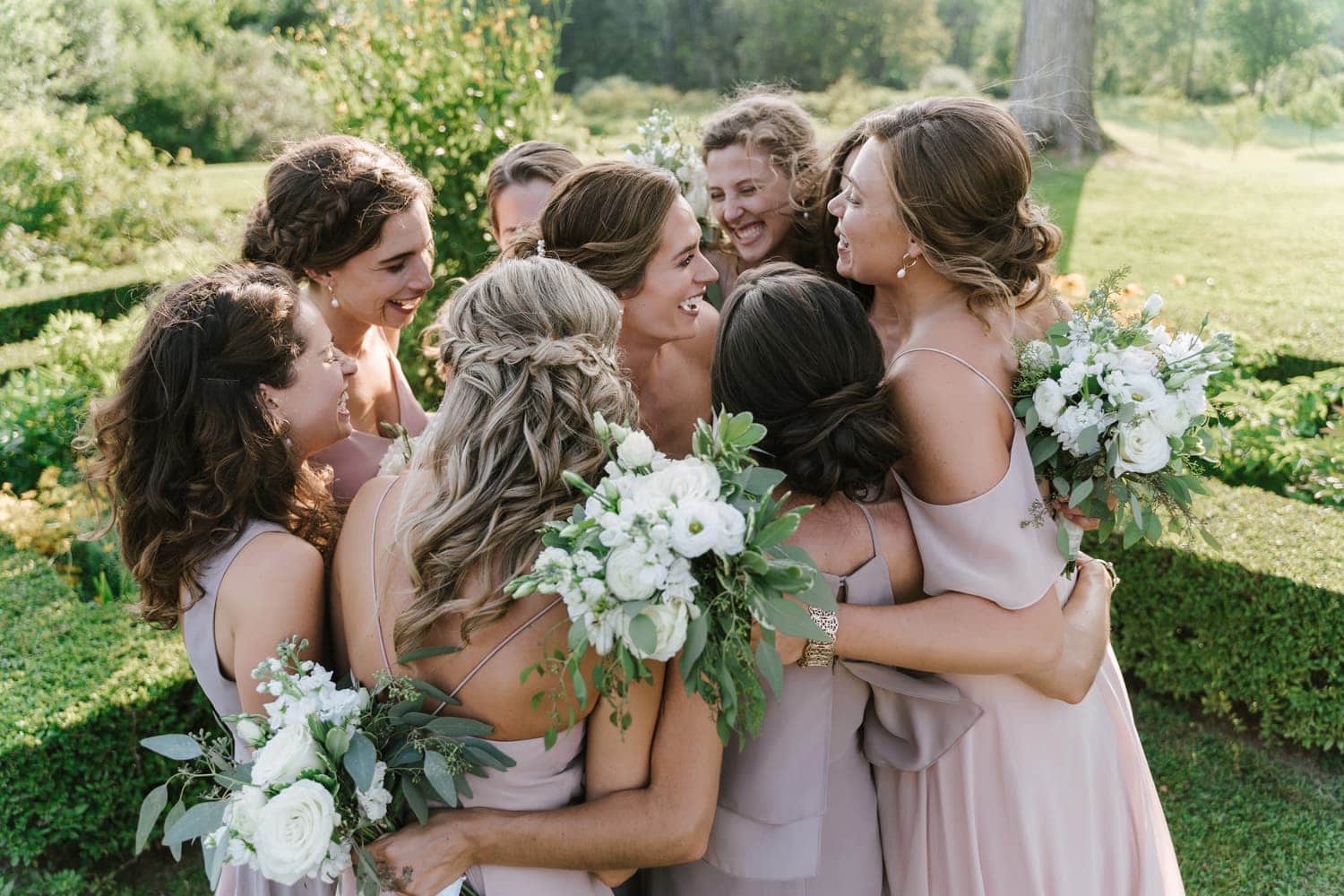 A bride hugging her bridesmaids