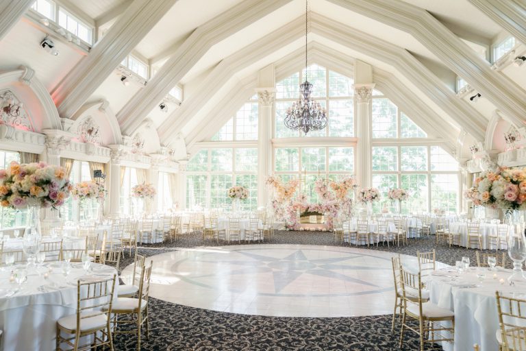 An elegant wedding reception setup at New Jersey wedding venue, featuring a beautifully decorated indoor space with floral arrangements