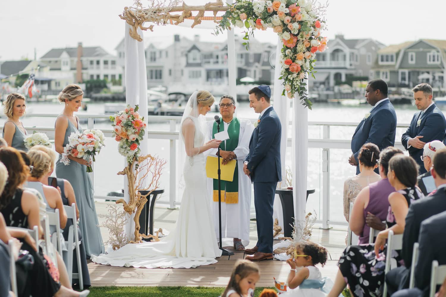 Bride and groom reading their vows during waterfront ceremony in New Jersey