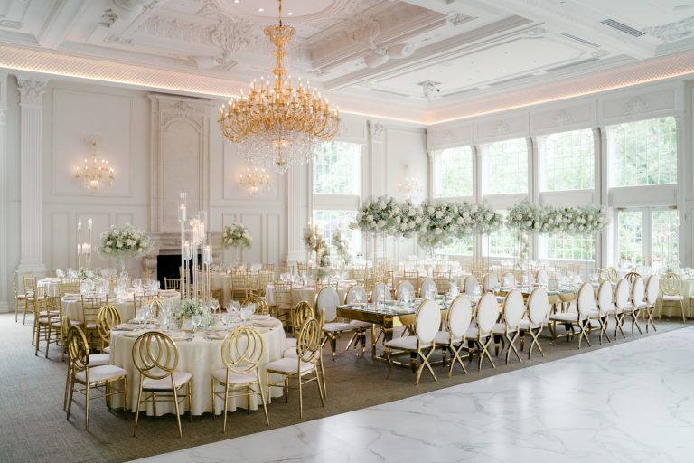 "An elegant wedding reception setup at the estate of Florentine Gardens in New Jersey, featuring a beautifully decorated outdoor space with floral arrangements