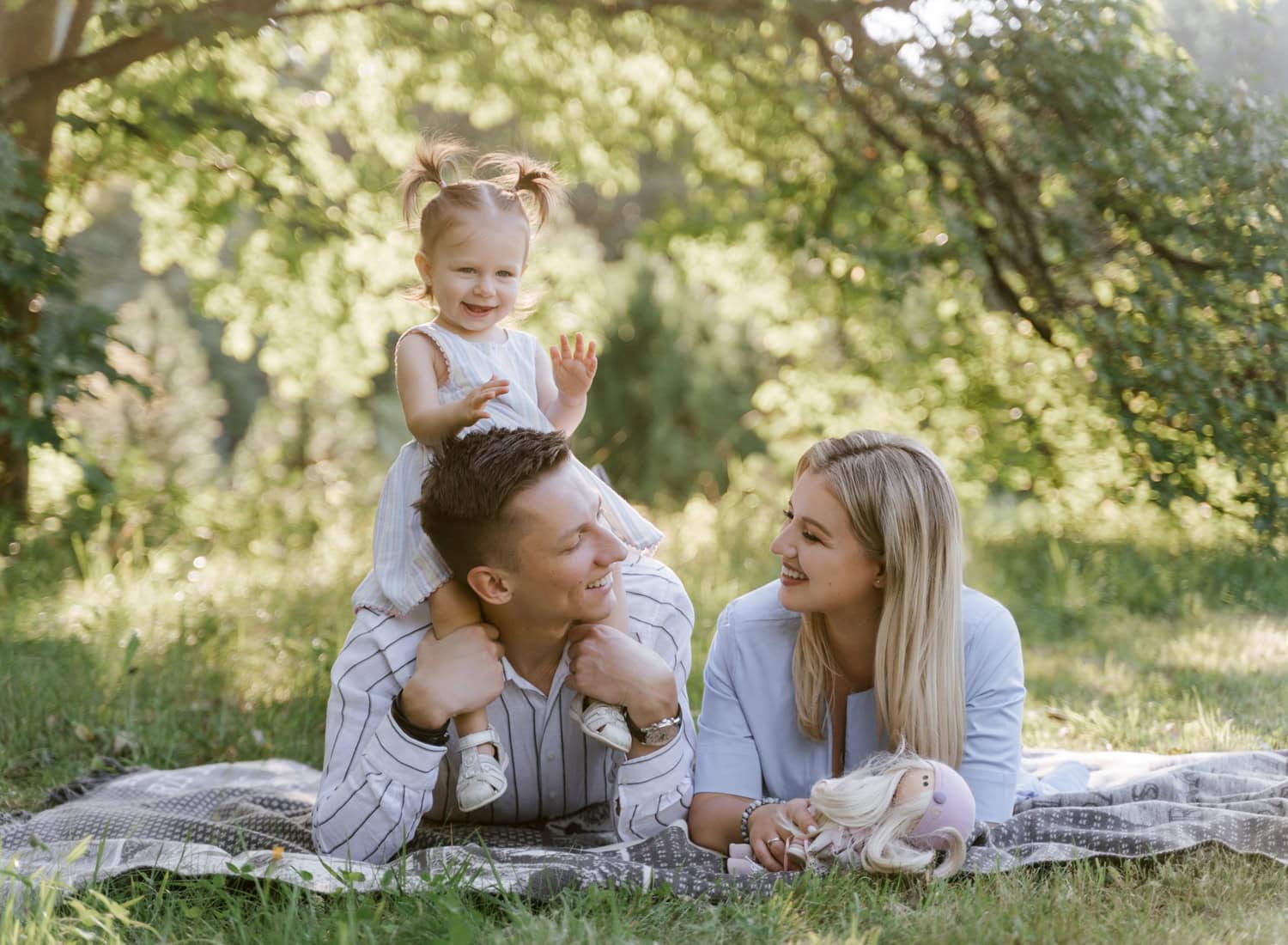 A joyful family enjoying a playful moment on a picnic blanket, capturing the warmth and connection of a well-prepared family photo session.