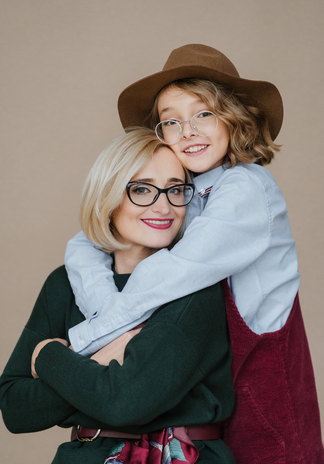 A heartwarming portrait of a mother and daughter embracing, captured during a family photo session.