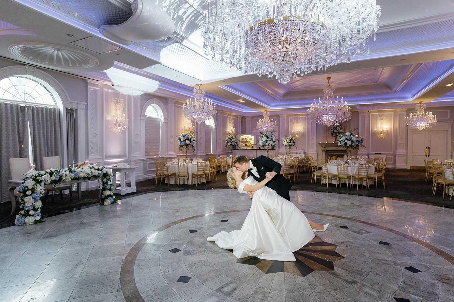 Romantic first dance at The Rockleigh in New Jersey, featuring a grand ballroom with crystal chandeliers, elegant floral decor, and a polished marble dance floor.